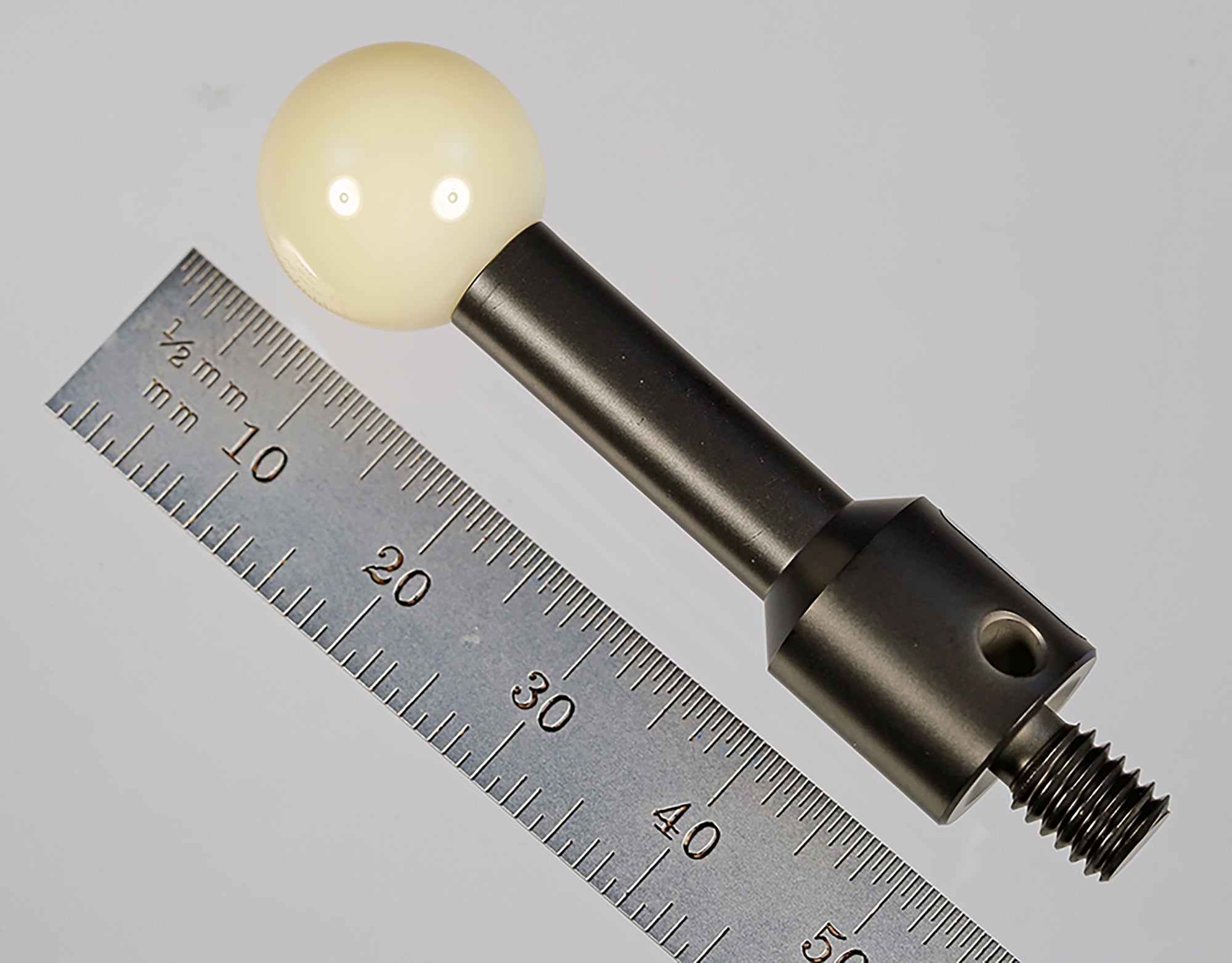 CAL-DK12-C M6 15.0 mm ceramic calibration sphere on a blackened stainless steel base.